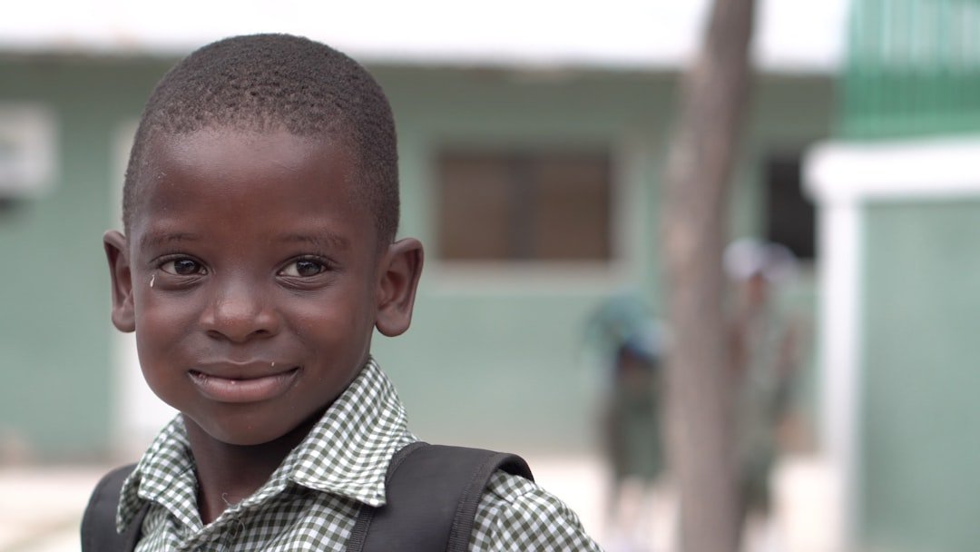 selective focus photography of boy wearing white collared shirt